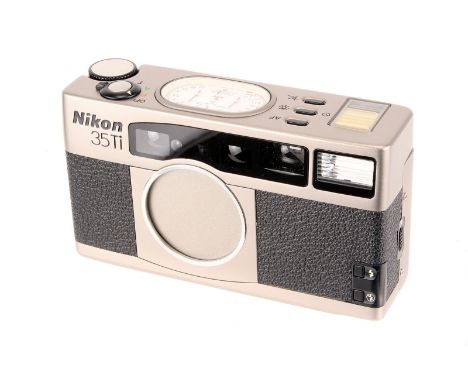 A Nikon 35TI Compact Camera, titanium, serial no. US4002105, with Nikon f/2.8 35mm lens, body, VG-E, lens, E, in maker’s soft