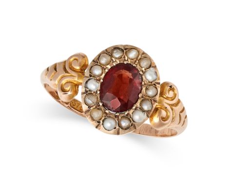 AN ANTIQUE GARNET AND PEARL RING in 9ct yellow gold, set with an oval cut garnet in a cluster of pearls, full British hallmar