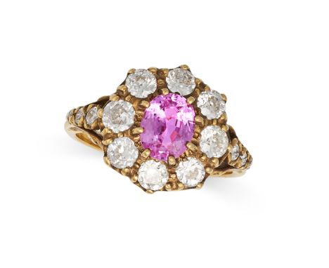 A VINTAGE PINK SAPPHIRE AND DIAMOND CLUSTER RING in 18ct yellow gold, set with an oval cut pink sapphire of approximately 1.5