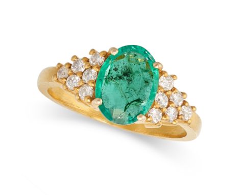 AN EMERALD AND DIAMOND RING in 14ct yellow gold, set with an oval cut emerald, the stepped shoulders set with round brilliant