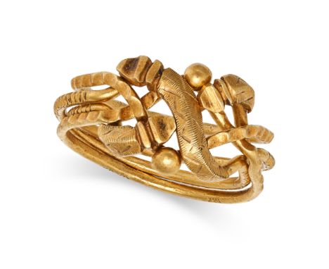 A GOLD PUZZLE RING comprising four bands joining together to form a scrolling ring, no assay marks, size K / 5.25, 5.2g.&nbsp