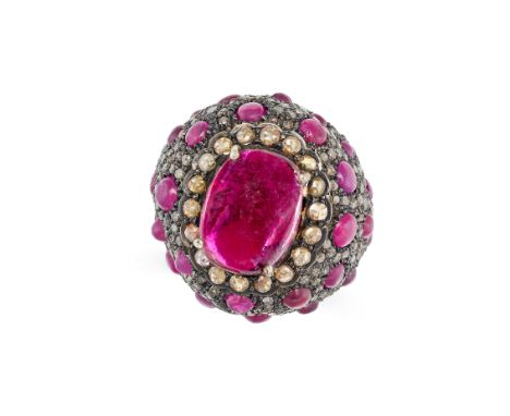 A PINK TOURMALINE AND DIAMOND BOMBE RING in silver, set with a cabochon tourmaline of approximately 7.41 carats in a border o