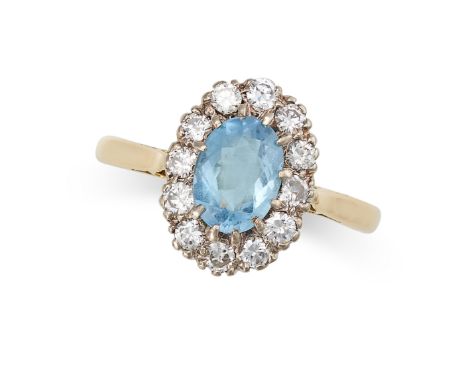 A VINTAGE AQUAMARINE AND DIAMOND CLUSTER RING in 18ct yellow gold, set with an oval cut aquamarine of approximately 0.91 cara