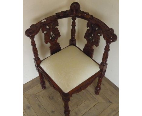 Chippendale style elaborately carved mahogany corner chair with drop-in upholstered seat, on turned supports 
