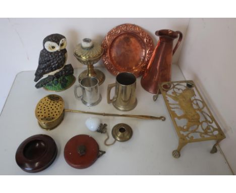 Cast metal doorstop in the form of an owl, brass trivets, a brass chestnut roaster, copper jug of tapering form, oil lamp bas