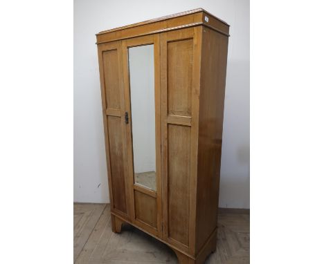 Edwardian light oak wardrobe with panelled front and single mirrored door (184cm x 94cm x 40cm) 