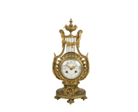 BELLE EPOQUE LYRE-SHAPED GILT METAL MANTEL CLOCK the case with a jewelled bezel surmounted by floral swags and urn finial, th