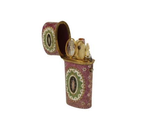 ENAMELLED ETUI OF TAPERING OVOID FORM the hinged lid revealing a fitted interior with assorted tools, the mottled mauve exter