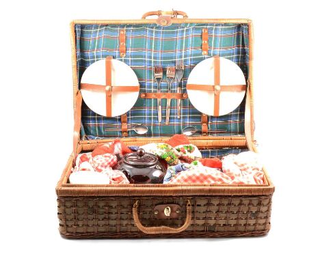 Vintage wicker picnic hamper, with fitted ceramic plates, loose non-matching cutlery and brown teapot, width 54cm.