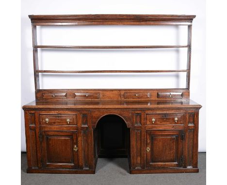 Large joined oak dresser, 18th Century and later, two shelf delft rack with spice drawers, base with two drawers, cupboards a