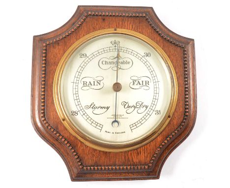 Oak cased aneroid barometer shield shape, silvered dial signed James Lucking, 27x26cm, and an oak framed wall mirror.Qty: 2Co