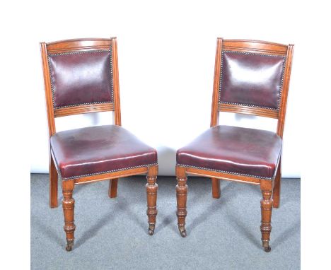 Set of seven Victorian walnut dining chairs, in the manner of Gillows, red leather close studded upholstery, turned and ringe