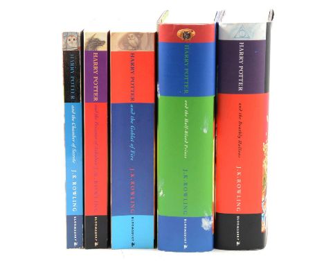Five various Harry Potter books, The Chamber of Secrets, Prisoner of Azkaban, Goblet of Fire, Deathly Hollows, and Half-Blood