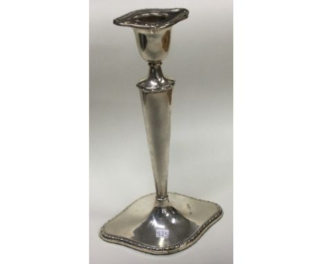 A large silver candlestick. London 1908. By William Hutton & Sons. Approx. 367 grams. Est. £50 - £80.