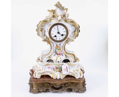 A 19th century French porcelain mantel clock, the enamelled dial showing Roman numerals, having eight-day movement, the Rococ