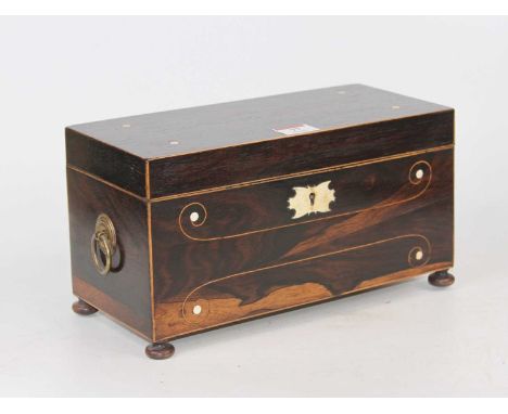 A Regency rosewood and boxwood strung tea caddy, having inset ivory roundels and an ivory escutcheon, the hinged lid opening 
