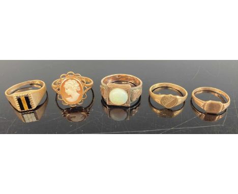 Two 9ct gold child's signet rings; together with a 9ct gold black onyx set signet ring (cut); a 9ct gold cameo set ring; and 