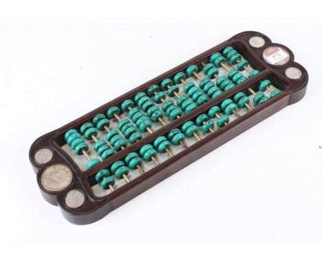 A Chinese hardwood abacus, inset with coins, w.41cm