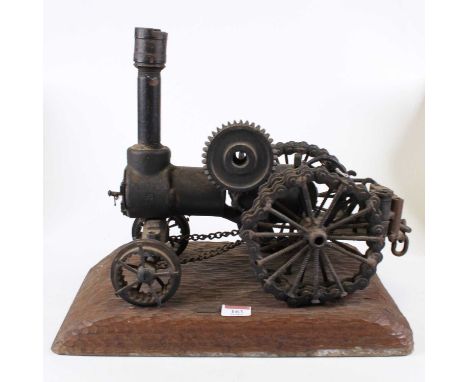 A model traction steam engine, constructed from chains and screws, mounted upon a wooden plinth, h.35cm 