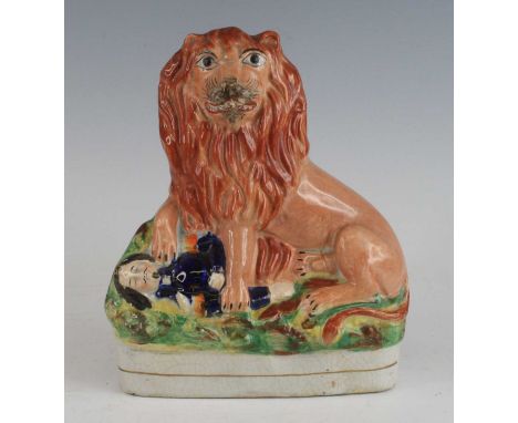 A Staffordshire model of the British lion over Napoleon III, circa 1860, the lion shown with paws raised over the figure, h.2