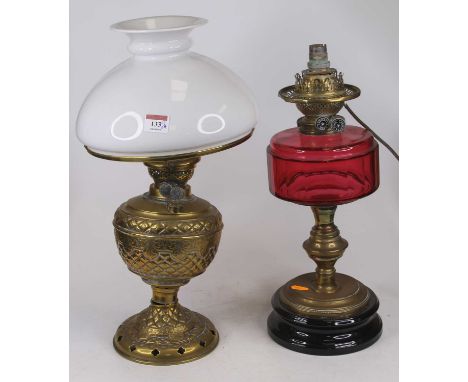 A Victorian brass oil lamp, having a milk glass shade, h.47cm; together with another Victorian brass oil lamp, having a cranb