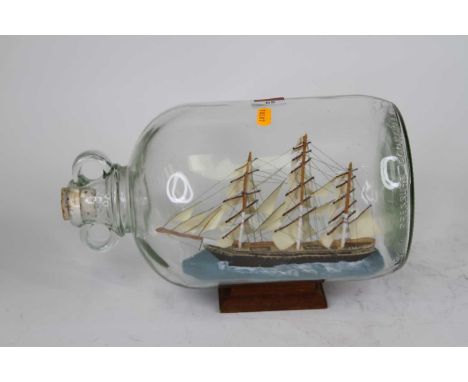 A model of the Cutty Sark contained within a glass jar, height 20cm