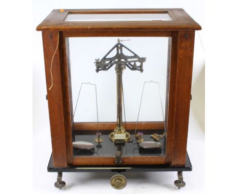 A mahogany cased set of brass scales, h.51cm, w.43cm, d.29cm 