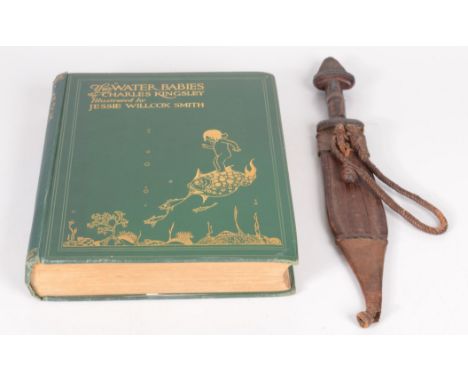 An African steel dagger, with leather handle and scabbard, length 36cm and a book entitled 'The Water Babies' by Charles King