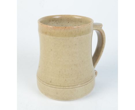 A Leach pottery cream glazed mug, impressed mark to base, height 11.7cm. 