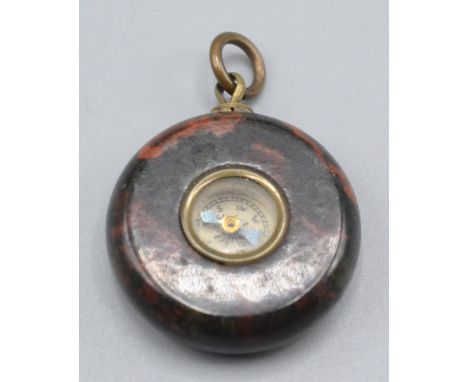 A red serpentine compass fob.