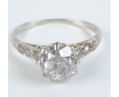 A high purity white gold diamond solitaire ring of approximately 1.25ct each shoulder set with a line of 3 small diamonds.   