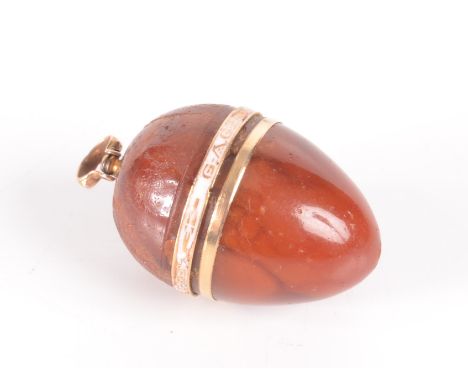 A George III amber and gold egg pendant enamelled in white about its girth on a gold band "gage de mon amitié" 33mm.   Condit