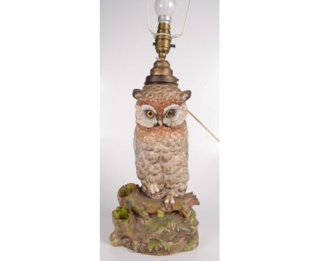 A German porcelain lamp base in the form of an owl, with blue crossed swords mark to base, with cream silk beaded shade, heig