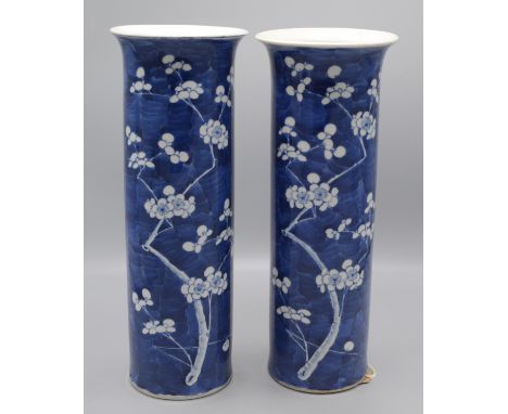 Two similar Chinese blue and white porcelain cylindrical vases, late 19th century, decorated with prunus blossom, four charac