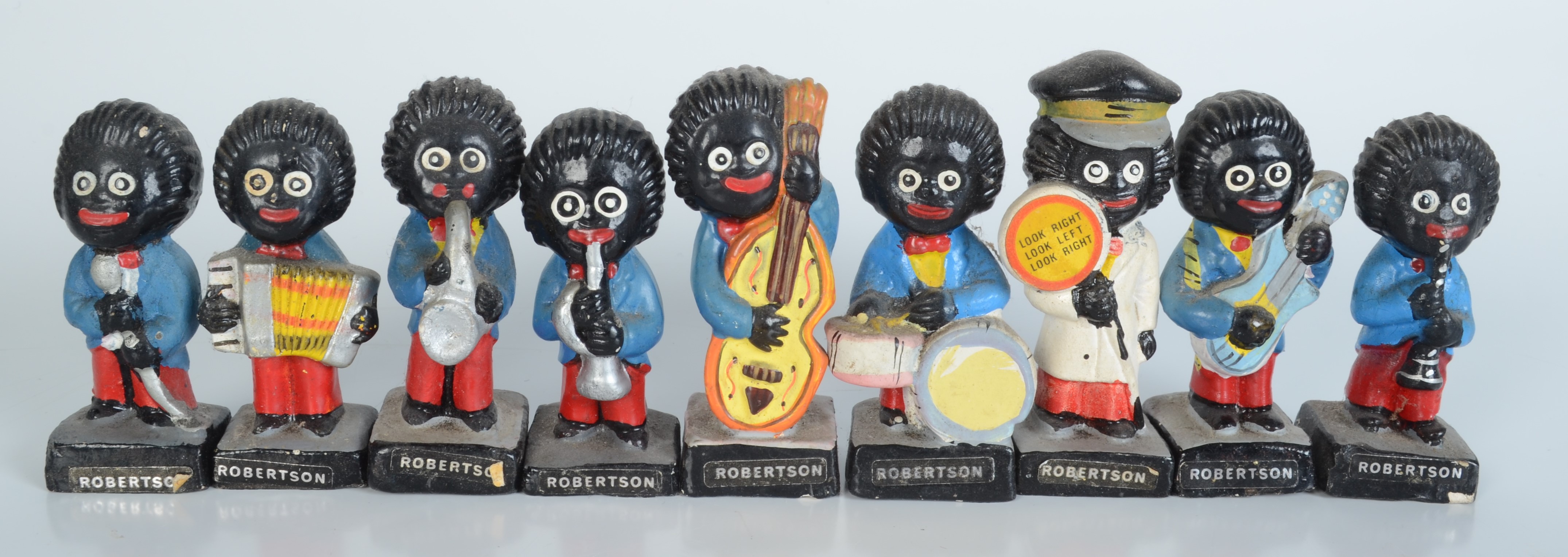 A set of eight Robinsons golliwog band figures, height of tallest 7.5cm