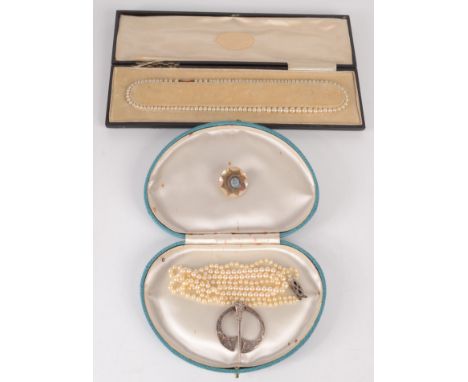 Two pearl necklaces, a silver Celtic pin and an RASC badge.