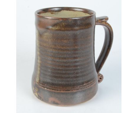 A Leach pottery brown glazed mug, impressed mark to base, height 12.3cm. 