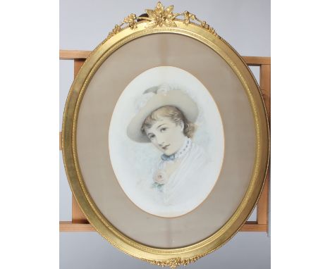 A pastel portrait of a lady, late 19th/early 20th century, monogrammed A.V.H., in an oval gilt frame surmounted by floral dec