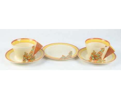 Two Clarice Cliff Bizarre cups and saucers in the 'Sunshine' pattern, height of cups 6.5cm, diameter of saucers 14.4cm and a 