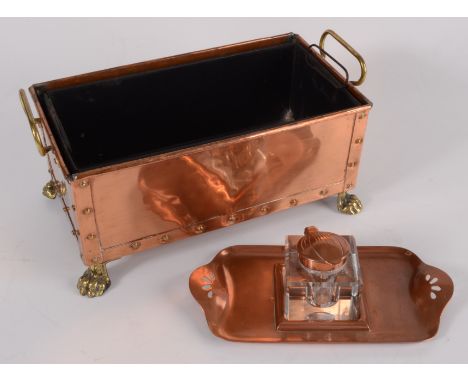 An Art Nouveau copper inkstand, impressed no 'D.L.P. 10385 and P.G.M 168180', length 21cm, and a copper planter, with brass h