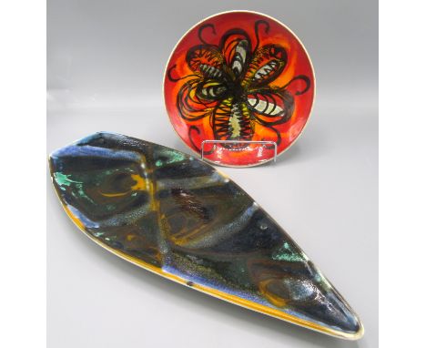 A Poole Pottery dish with lustre glaze and abstract designs, length 43, width 17.5cm and a Poole Pottery plate with a red gro