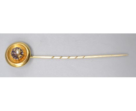 A Victorian high purity gold stick pin the finial with a bowl holding and an enamelled diamond set scallop shell and a pearl,