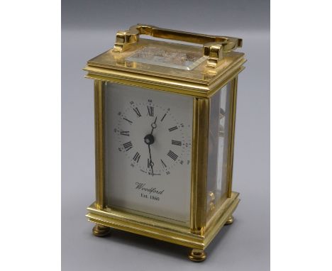 A gilt metal carriage clock, 20th century, the rectangular white dial inscribed 'Woodford Est.1860', height 11.3cm, width 8cm