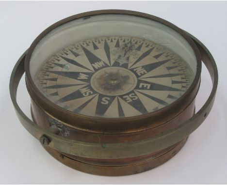 A brass ships compass, total diameter 26cm, height 10.5cm.