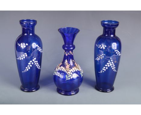 A pair of blue glass vases, early 20th century, with gilt and enamel decoration, height 28.5cm and a similar baluster vase, h