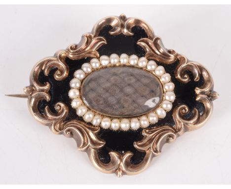 A Victorian high purity gold mourning brooch with an oval of plaited hair, surrounded by pearls on a black enamel ground with