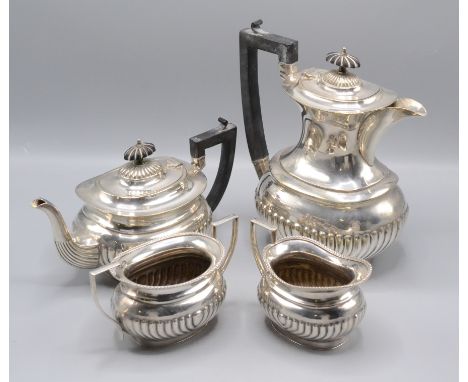 A silver plated Lonsdale four piece tea service, with ebonised handles and finials, height of hot water jug 24cm.