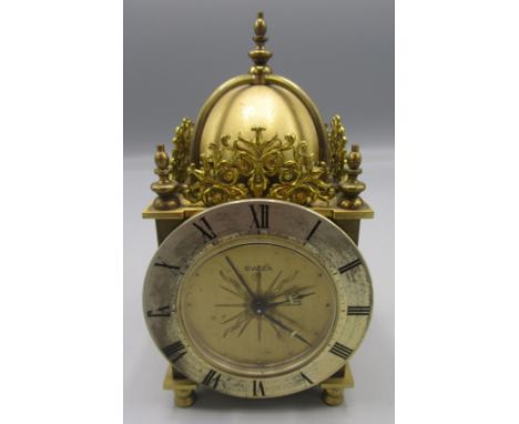 A Swiza 8 miniature brass lantern style clock, height 13cm, diameter of dial 7.2cm.