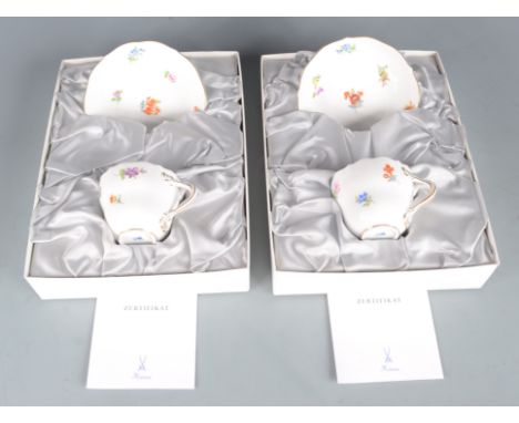 Two contemporary Meissen cups and saucers, boxed, with certification. 