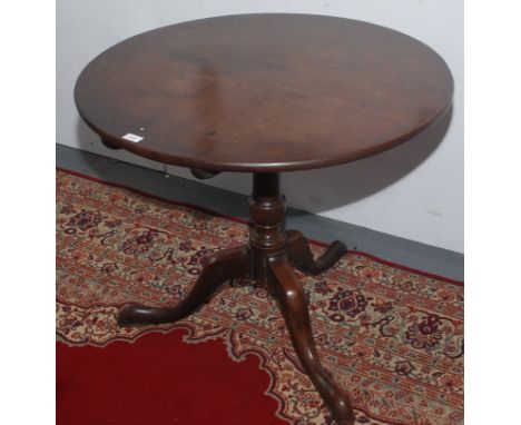 A George III mahogany tripod table, the snap top on a baluster stem and cabriole supports on pad feet, height 71cm, diameter 